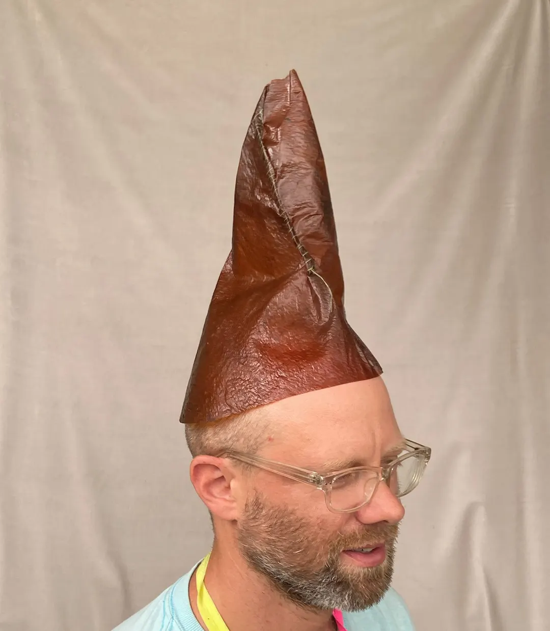 Photo portrait of Doug in glass and short beard, and wearing a long pointy hat made of kelp.