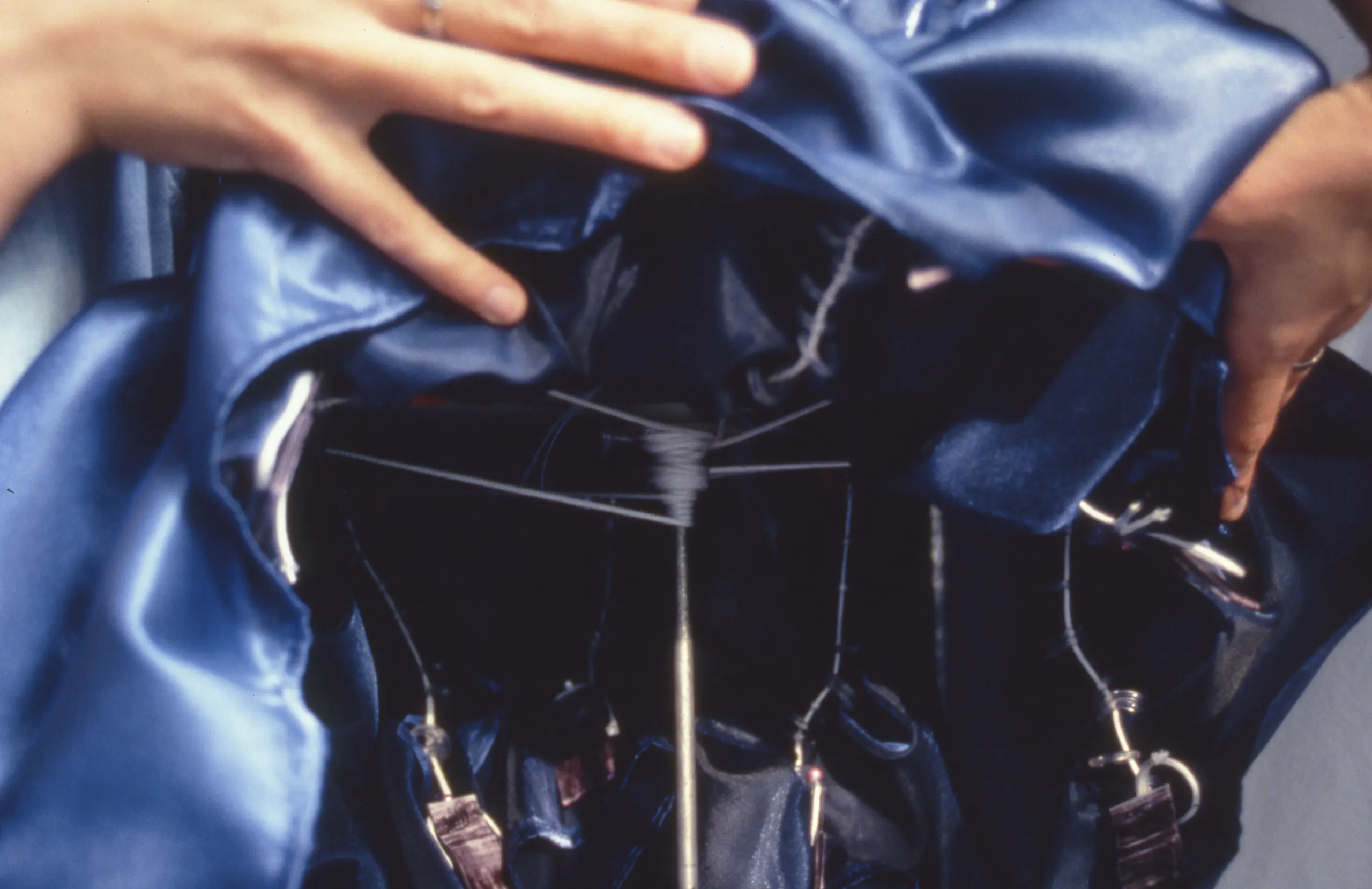 Close up photo a blue dress being lifted up to reveal mechatronics underneath.